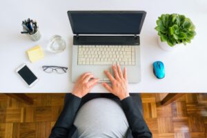Pregnant Employee Working on Laptop